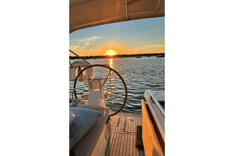 Slide: The Image of Beneteau Oceanis 40.1 sailboat at sunset, 2021 model, serene water view. - 1