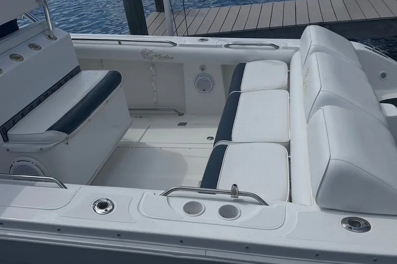 Slide: The Image of 2003 Marlago 35 FS boat interior with white seating and cup holders. - 16