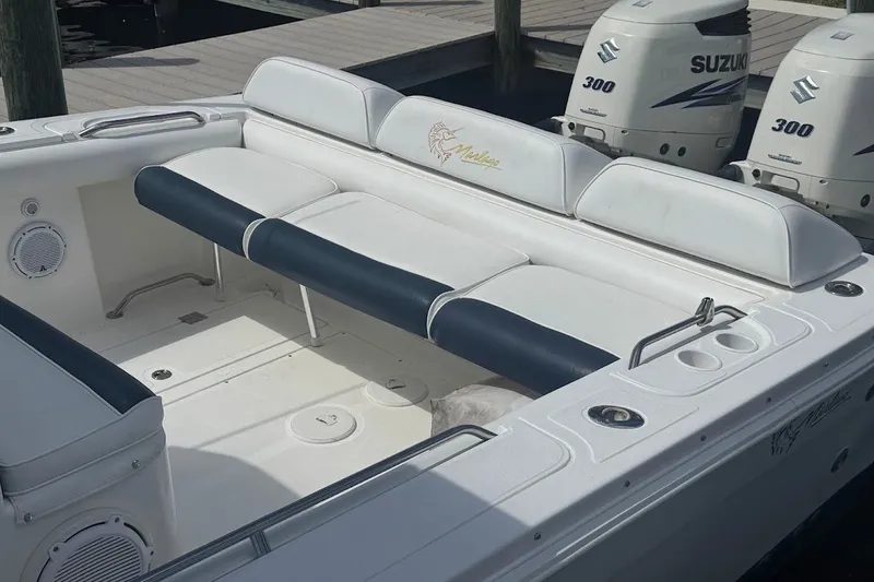 Slide: The Image of 2003 Marlago 35 FS boat interior with seating and Suzuki engines. - 17