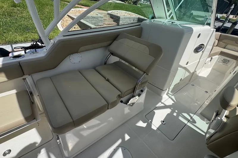 Slide: The Image of 2020 Sailfish 245 DC boat interior with beige seating and sleek design. - 24