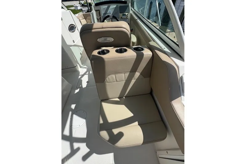 Slide: The Image of 2020 Sailfish 245 DC boat interior with beige seating and cup holders. - 19