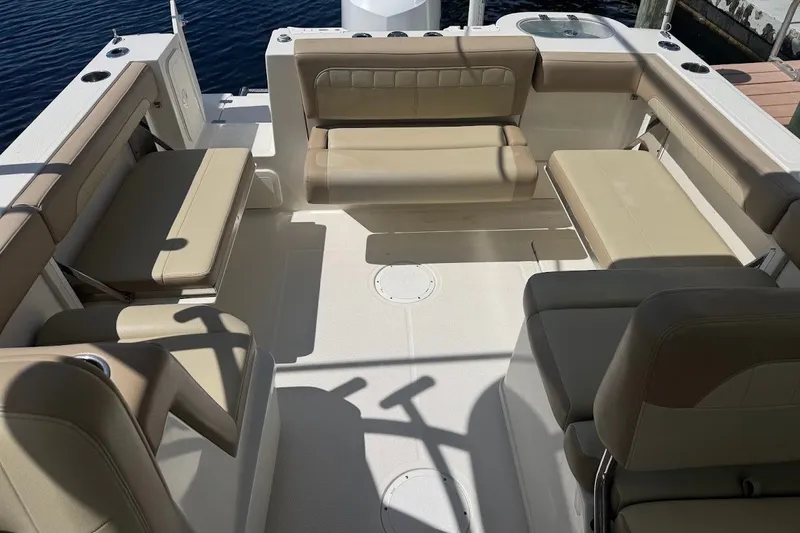 Slide: The Image of 2020 Sailfish 245 DC boat interior with beige seating and spacious layout. - 23