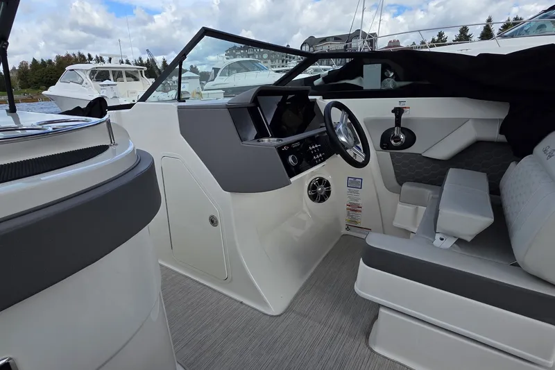 Slide: The Image of 2020 Sea Ray SDX 290 boat interior with steering wheel and seating. - 24