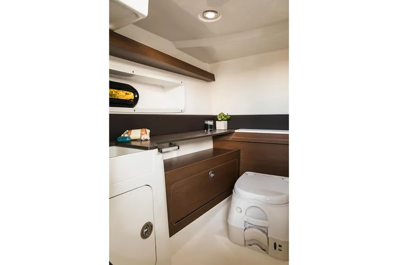 Slide: The Image of Manufacturer Provided Image: Interior cabin of 2020 Sea Ray SDX 290 boat with toilet and storage. - 3