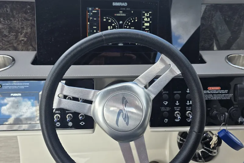 Slide: The Image of Steering wheel and dashboard of 2020 Sea Ray SDX 290 boat with control panel. - 23