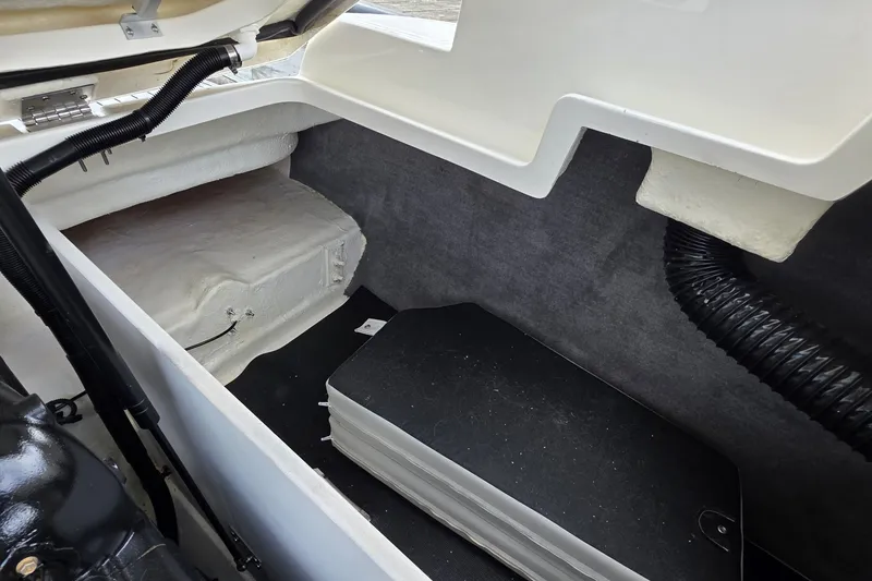 Slide: The Image of Interior storage compartment of 2020 Sea Ray SDX 290 boat, featuring organized space and wiring. - 15