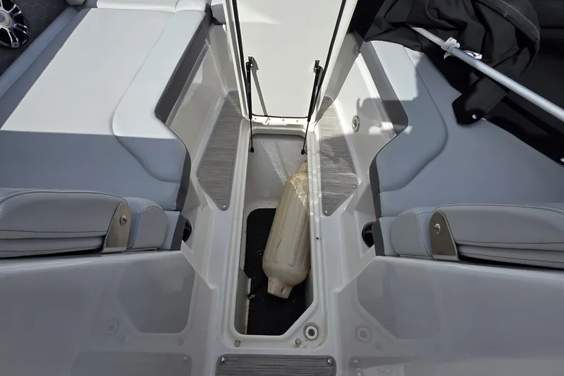 Slide: The Image of 2020 Sea Ray SDX 290 interior storage compartment with seating and accessories. - 19