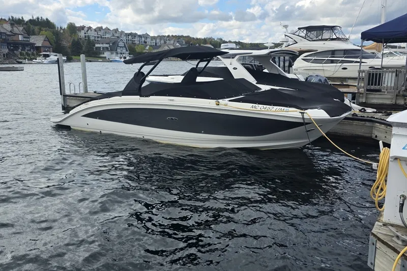 The Image of 2020 Sea Ray SDX 290 boat docked at a marina with scenic waterfront views. - 0