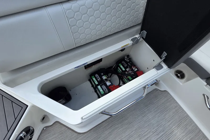 Slide: The Image of Storage compartment with batteries in a 2020 Sea Ray SDX 290 boat. - 8