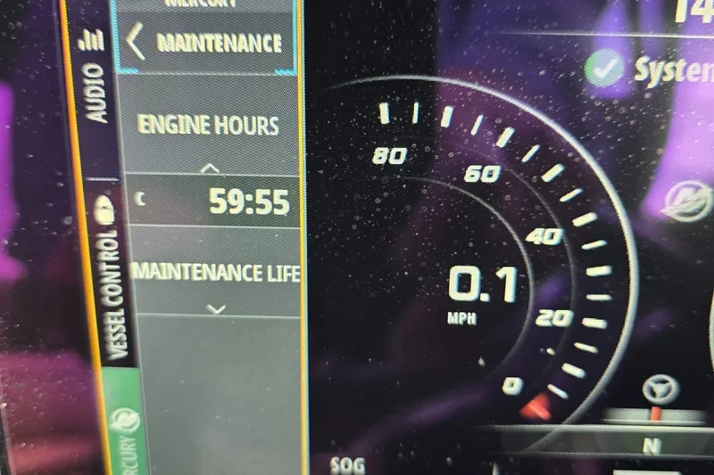 Slide: The Image of Dashboard of 2020 Sea Ray SDX 290 showing 59:55 engine hours and 0.1 MPH speed. - 17