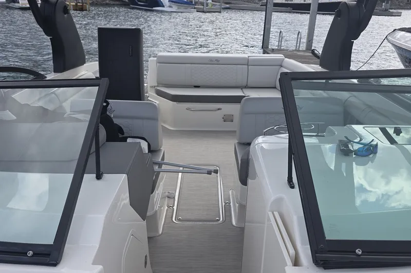 Slide: The Image of 2020 Sea Ray SDX 290 boat interior with seating and windshield, docked by the water. - 22