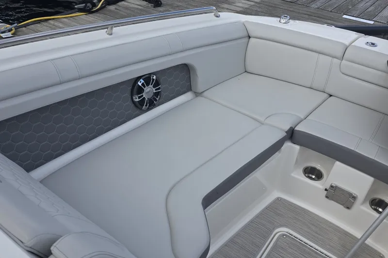 Slide: The Image of 2020 Sea Ray SDX 290 boat interior with cushioned seating and speaker detail. - 21