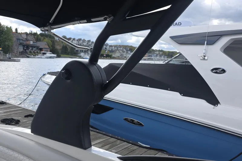 Slide: The Image of 2020 Sea Ray SDX 290 boat docked by a scenic waterfront. - 28