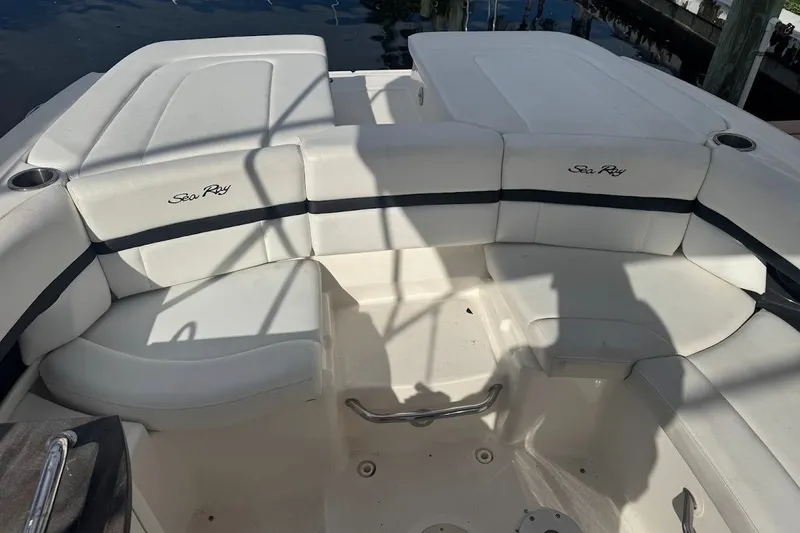 Slide: The Image of 2014 Sea Ray SLX 250 boat interior with white seating and cup holders. - 15