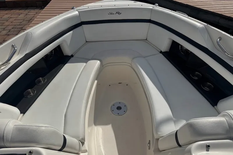 Slide: The Image of 2014 Sea Ray SLX 250 boat interior with white seating and cup holders. - 14