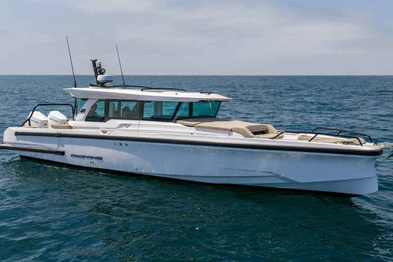 Slide: The Image of 2027 Axopar 38 XC Cross Cabin boat cruising on open sea. - 1
