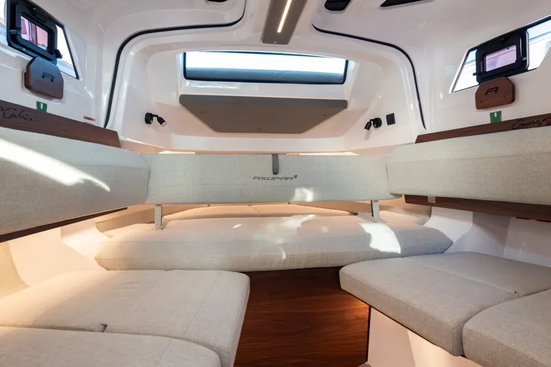Slide: The Image of Luxurious interior of 2027 Axopar 38 XC Cross Cabin with modern seating and ample natural light. - 25