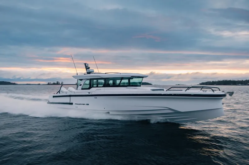 The Image of 2027 Axopar 38 XC Cross Cabin cruising on open water at sunset. - 0