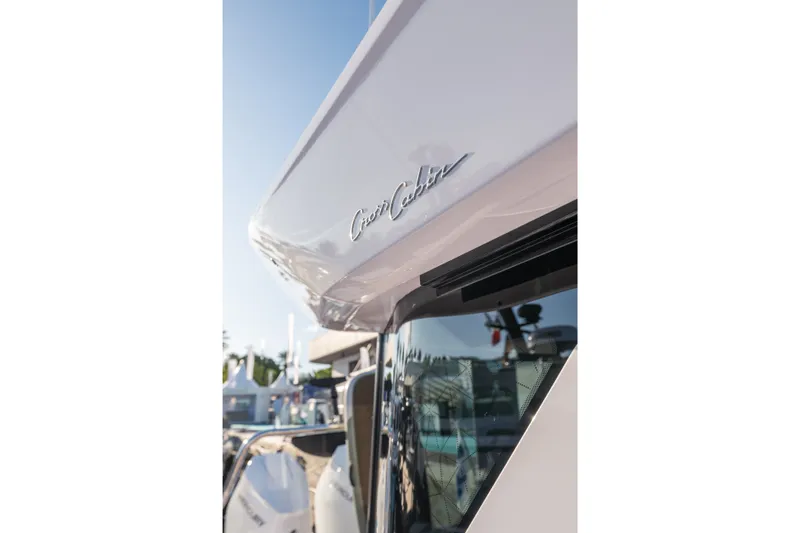 Slide: The Image of 2027 Axopar 38 XC Cross Cabin boat exterior detail with logo. - 9