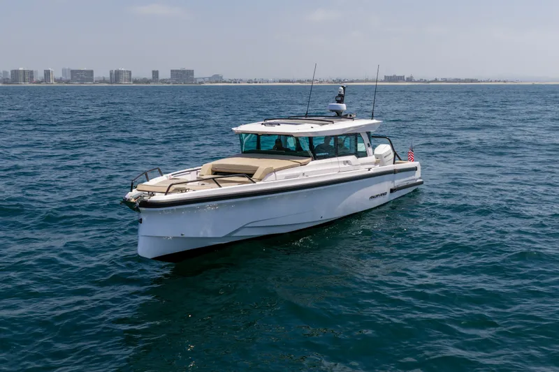 Slide: The Image of 2027 Axopar 38 XC Cross Cabin boat cruising on open water. - 3