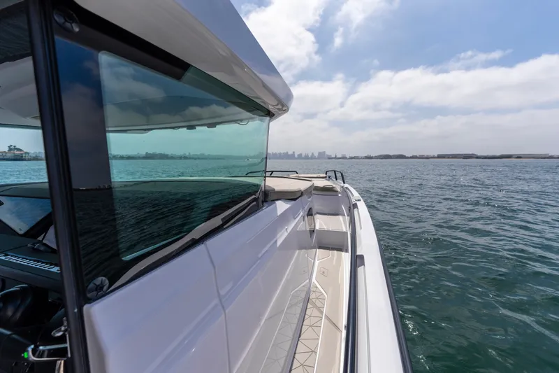 Slide: The Image of 2027 Axopar 38 XC Cross Cabin cruising on open water under a clear sky. - 7