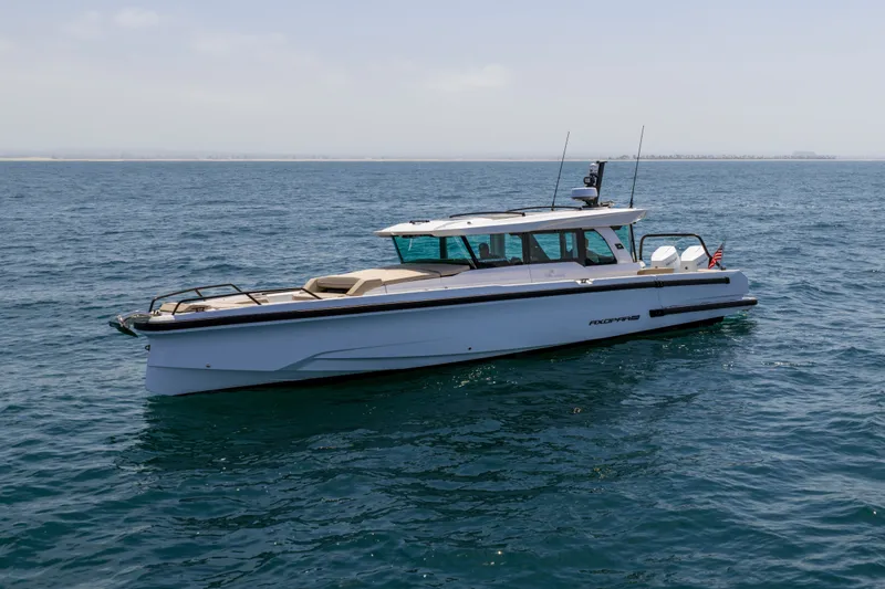 Slide: The Image of 2027 Axopar 38 XC Cross Cabin boat cruising on open water. - 4