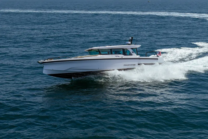 Slide: The Image of 2027 Axopar 38 XC Cross Cabin cruising on open water. - 5