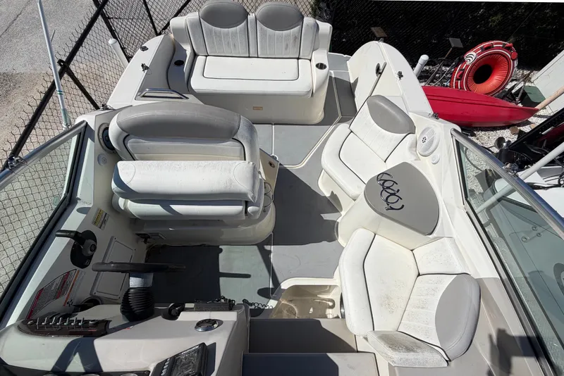 Slide: The Image of 2007 Sea Ray 240 Sundancer boat interior with white seating and control panel. - 44