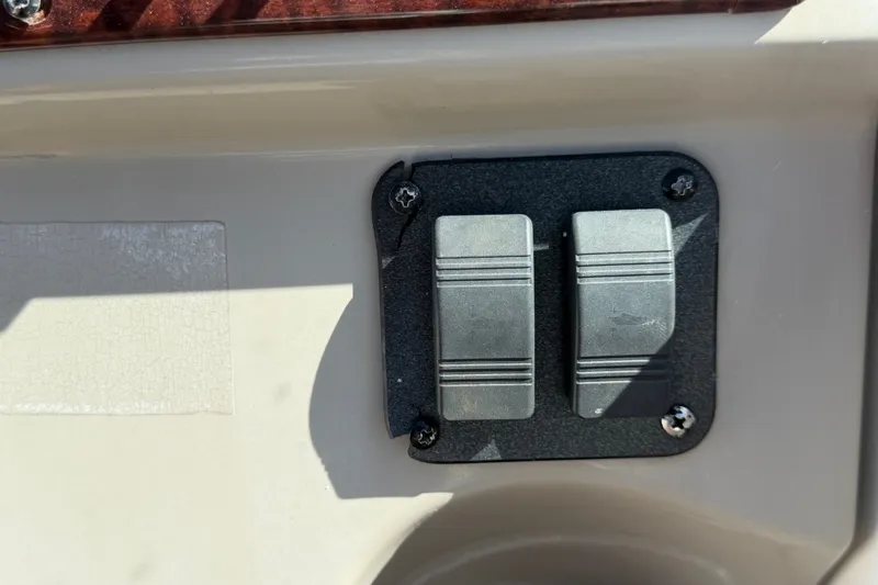 Slide: The Image of Control panel switches on a 2007 Sea Ray 240 Sundancer boat. - 33