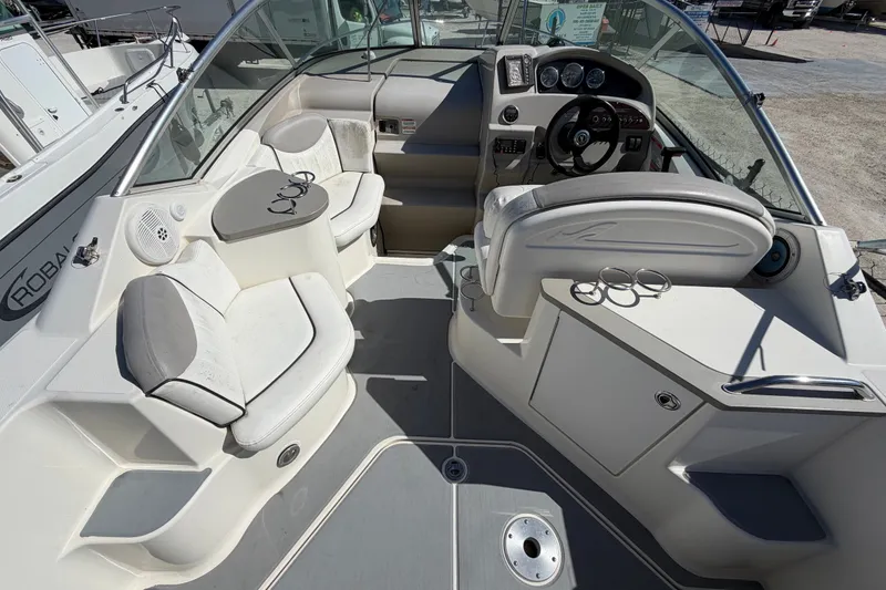 Slide: The Image of 2007 Sea Ray 240 Sundancer boat interior with seating and steering wheel. - 18