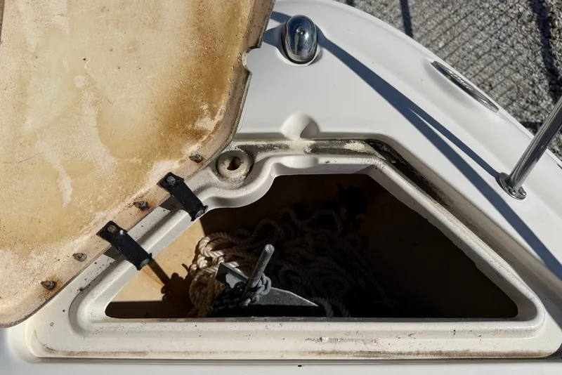 Slide: The Image of Anchor compartment of 2007 Sea Ray 240 Sundancer boat with visible rope and anchor. - 40