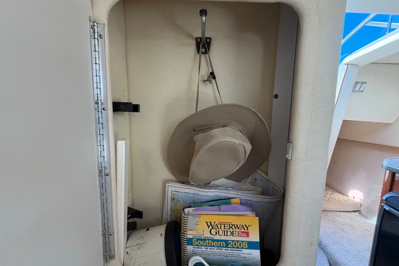Slide: The Image of Storage compartment in a 2007 Sea Ray 240 Sundancer with hat and waterway guide. - 67