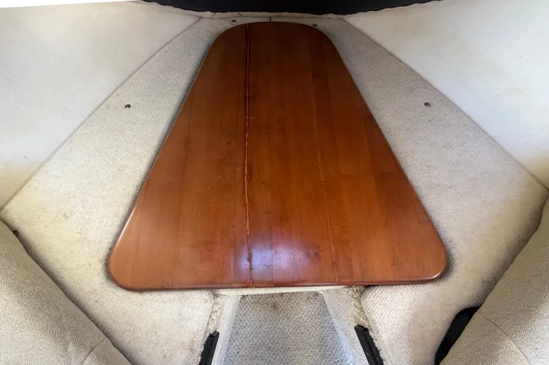 Slide: The Image of Interior view of 2007 Sea Ray 240 Sundancer with wooden table and beige seating. - 61