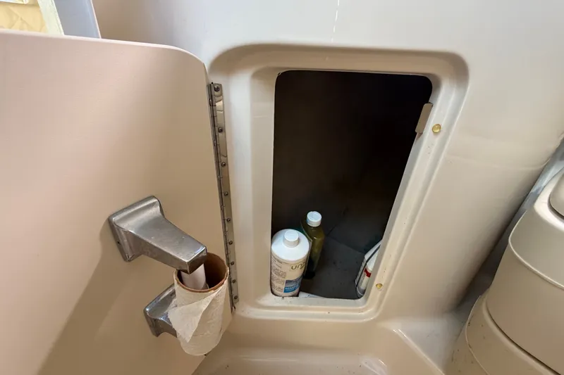 Slide: The Image of Storage compartment on a 2007 Sea Ray 240 Sundancer boat with cleaning supplies. - 73