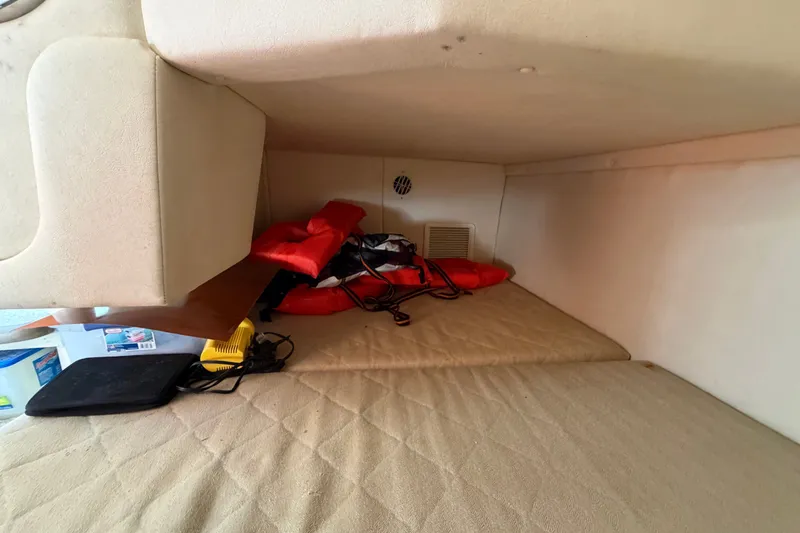 Slide: The Image of Interior cabin of 2007 Sea Ray 240 Sundancer with life jackets and equipment. - 77