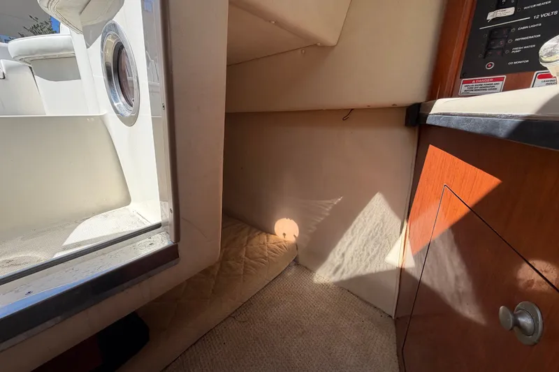 Slide: The Image of Interior cabin view of a 2007 Sea Ray 240 Sundancer boat, featuring a cozy space. - 75