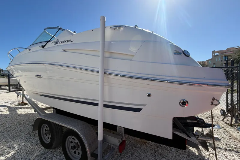 The Image of 2007 Sea Ray 240 Sundancer boat on trailer under clear blue sky. - 0