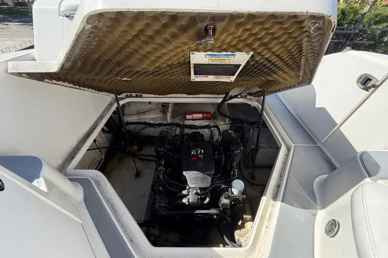 Slide: The Image of Open engine compartment of 2007 Sea Ray 240 Sundancer boat, showcasing engine and interior details. - 81