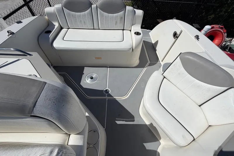 Slide: The Image of 2007 Sea Ray 240 Sundancer boat interior with white seating and gray flooring. - 79