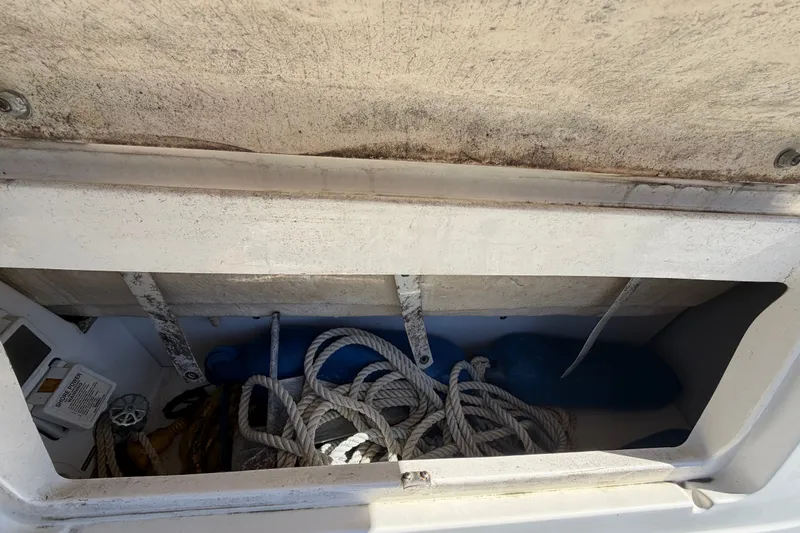Slide: The Image of Storage compartment of a 2007 Sea Ray 240 Sundancer with ropes and equipment. - 15