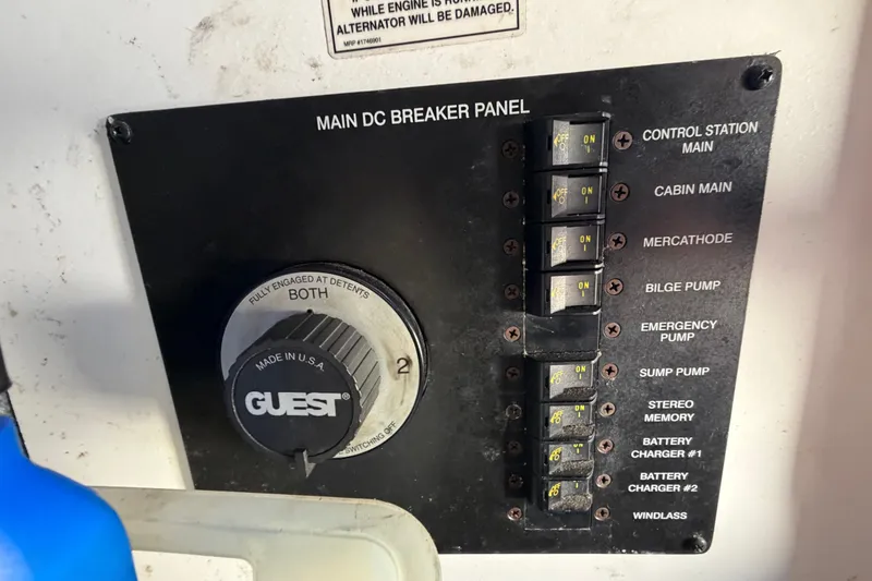 Slide: The Image of Main DC breaker panel on 2007 Sea Ray 240 Sundancer boat with labeled switches and dial. - 22