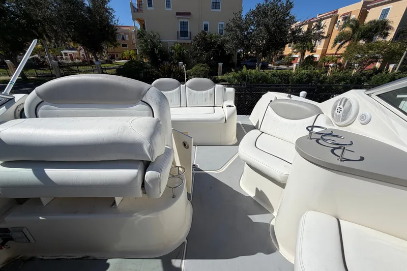 Slide: The Image of 2007 Sea Ray 240 Sundancer boat interior with white seating and cup holders. - 78