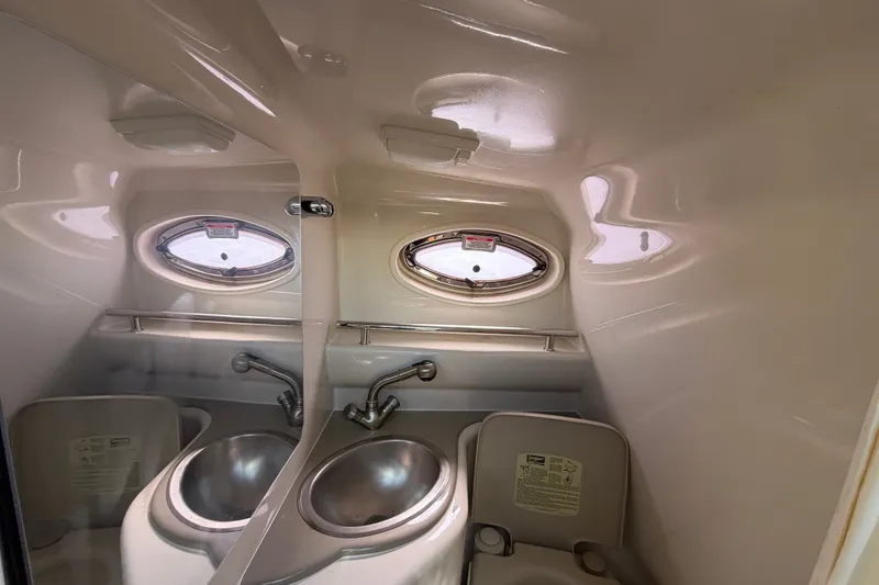 Slide: The Image of 2007 Sea Ray 240 Sundancer bathroom with sink and porthole window. - 70