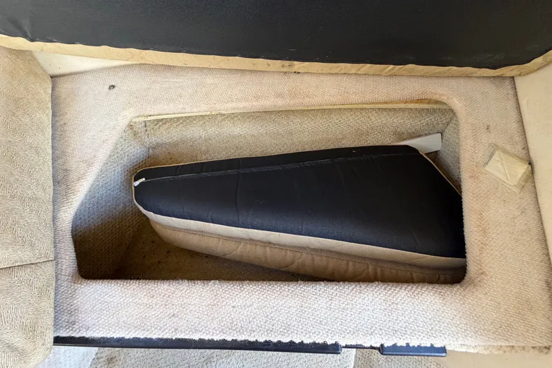 Slide: The Image of Interior detail of a 2007 Sea Ray 240 Sundancer boat, featuring a cushioned compartment. - 63