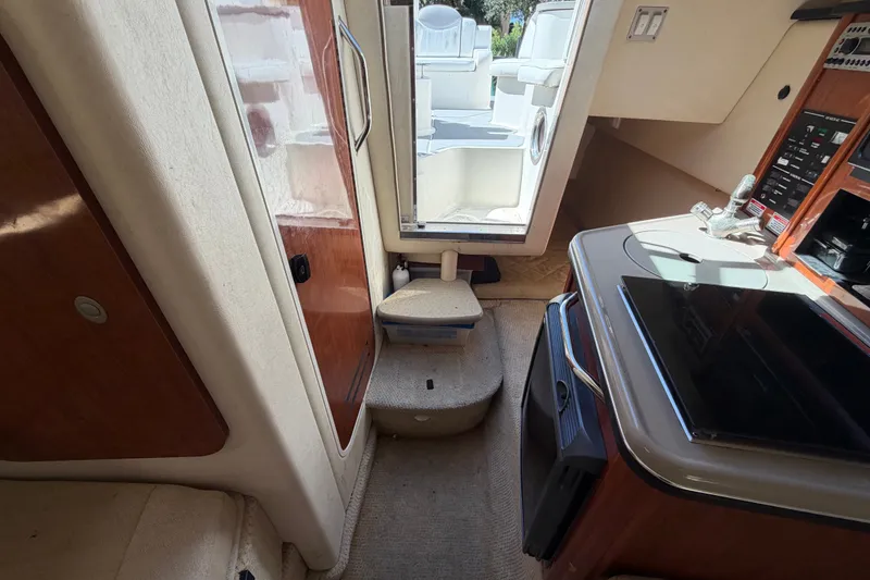 Slide: The Image of Interior view of a 2007 Sea Ray 240 Sundancer boat cabin with kitchenette and seating. - 64