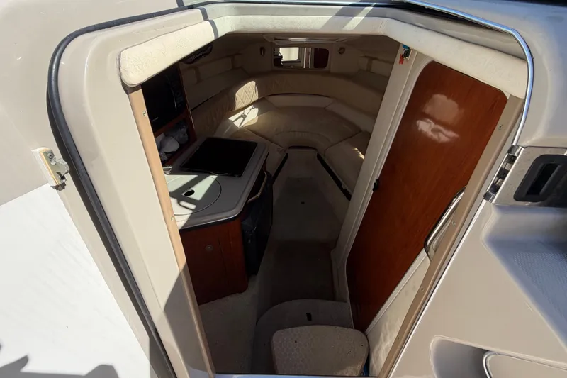 Slide: The Image of Interior cabin of a 2007 Sea Ray 240 Sundancer boat, featuring seating and kitchenette. - 45