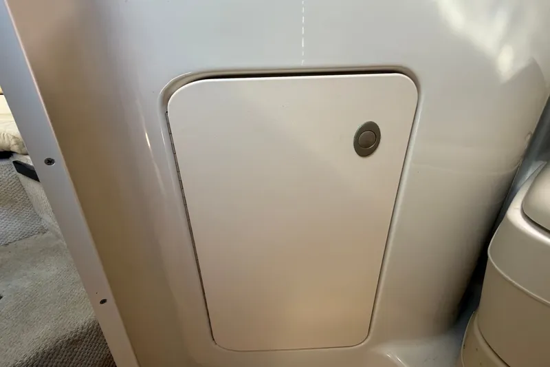 Slide: The Image of 2007 Sea Ray 240 Sundancer cabin interior with a closed storage compartment. - 72