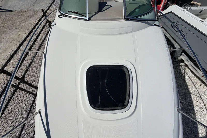 Slide: The Image of 2007 Sea Ray 240 Sundancer boat deck with hatch and windshield. - 41