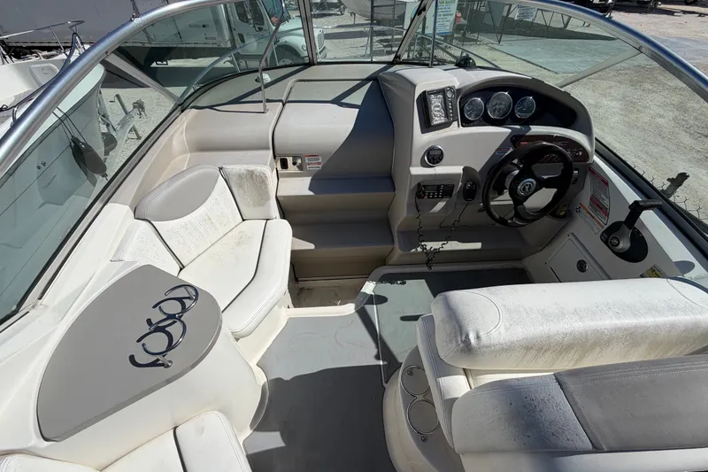 Slide: The Image of 2007 Sea Ray 240 Sundancer boat interior with steering wheel and seating area. - 25
