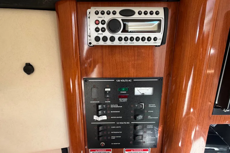 Slide: The Image of 2007 Sea Ray 240 Sundancer control panel with stereo and electrical switches. - 49